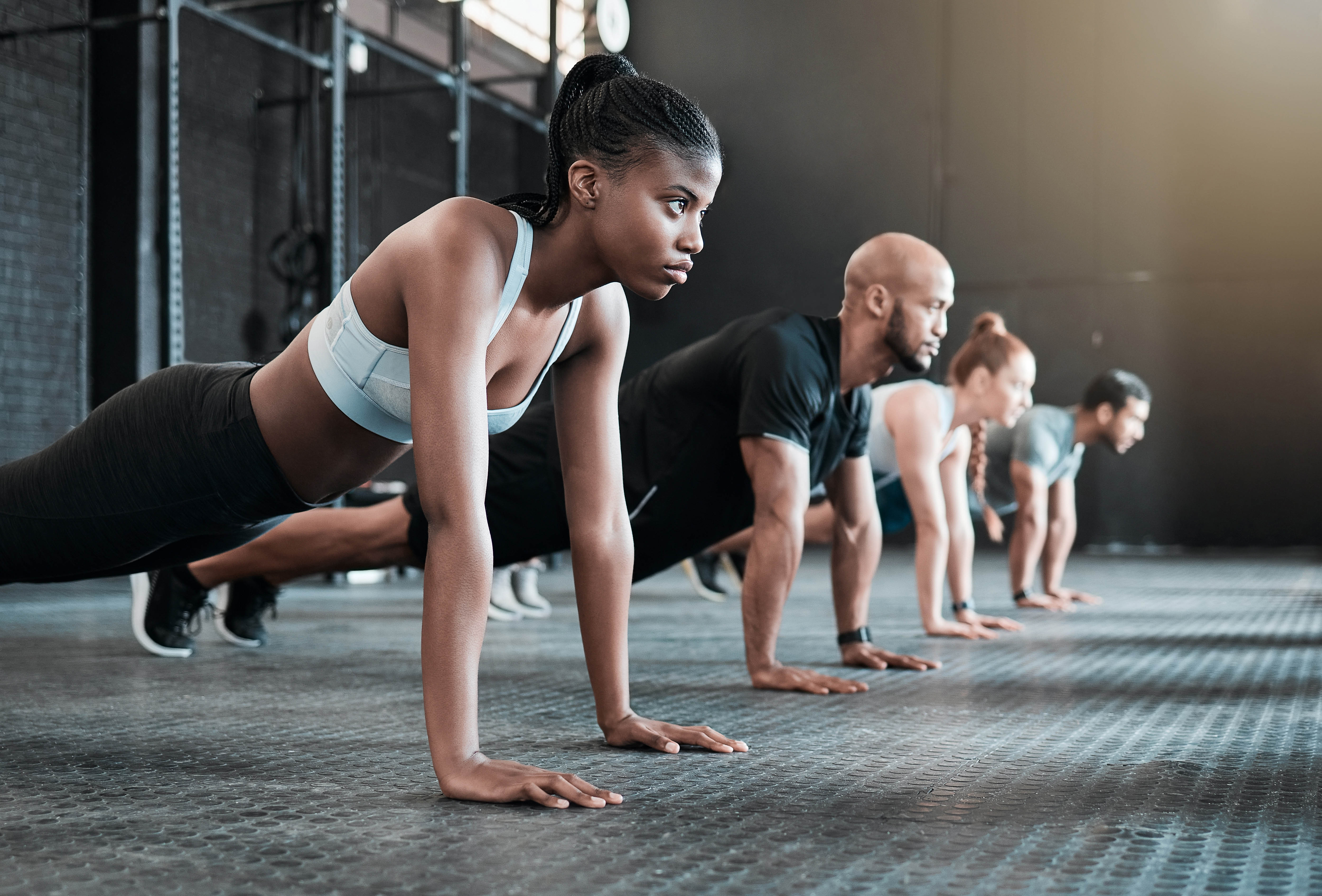 Group doing planks in a group fitness class at the gym